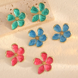 Three pairs of colorful enamel flower stud earrings in turquoise, blue, and magenta with gold trim
