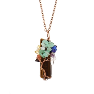 Detail of handmade wire-wrapped tree of life pendant with colorful natural stones