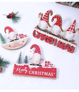 Close-up of wooden Christmas gnome desktop ornaments on faux snow background