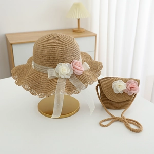 Detail of woven straw hat and matching floral bag set with soft organza ribbon ties