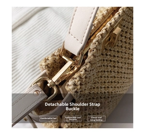 Macro detail of detachable gold-tone metal clasp on straw woven handbag strap
