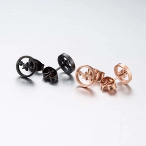 Detail view of geometric star and circle stud earrings in black and rose gold finish