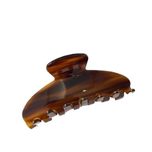 Large amber tortoiseshell acetate hair claw clip for elegant styling on white background
