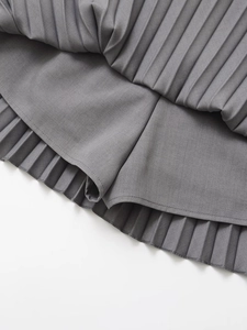 Detail view of grey pleated skort showing inner lining and fine twill fabric texture