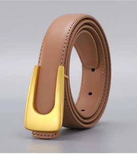 Detailed view of nude leather belt with matte gold U-buckle and premium stitching