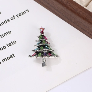 Detailed macro shot of vintage silver Christmas tree brooch with colorful crystals