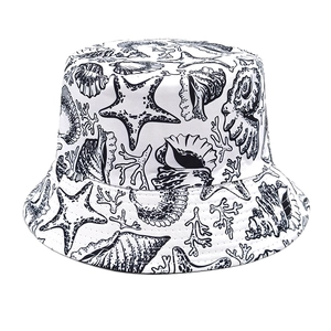 Detail of white bucket hat with black sea shells and starfish illustrations printed on fabric