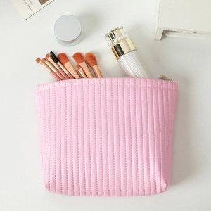 Pink quilted PU leather makeup bag showing internal storage for brushes and skincare bottles