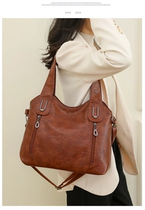 Brown vintage PU leather tote bag shown on a model featuring twin handles and side pockets