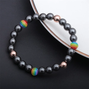 Close-up of hematite beaded bracelet with rainbow striped beads and rose gold accents