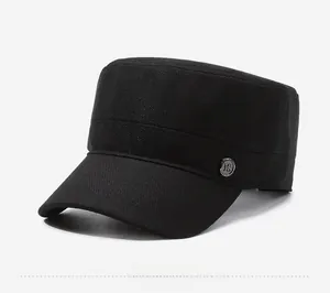 Detail view of the black cotton flat top cadet cap featuring a side metal emblem