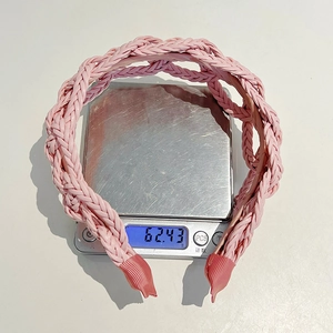 Close-up of pink braided leather headband showing woven texture and weight measurement