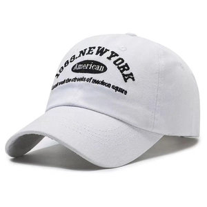 Detailed close-up of a white cotton baseball cap with 1969 New York black embroidery
