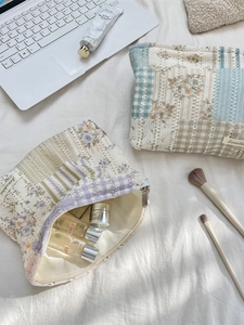 Quilted floral makeup bags with lace appliques in soft pastel blue and purple tones
