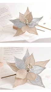 Detail of burlap Christmas flower with champagne gold finish and silver berry accents