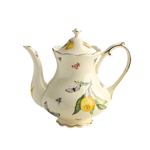 Vintage ceramic teapot with butterfly and lemon motifs and elegant gold trim accents