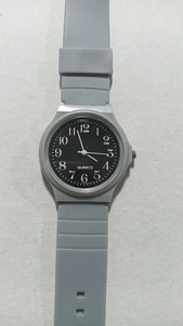 Detail shot of the silent quartz exam watch with grey strap and black dial
