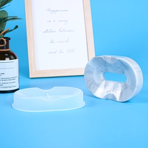 Detail view of oval silicone mold and marble-textured DIY soap dish resin finished piece