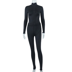 Detail of black slim fit yoga set with stand collar zipper jacket and leggings