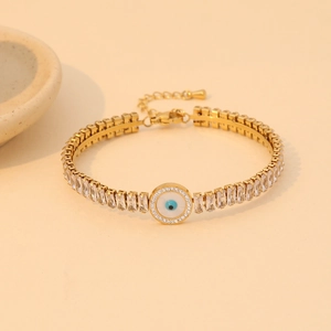 Golden stainless steel bracelet with zircon stones and blue evil eye charm ornament