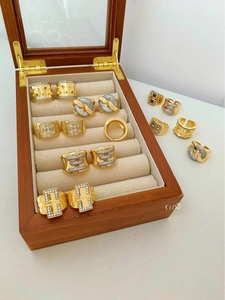 Macro view of gold-plated rings set with cubic zirconia in a wooden jewelry box