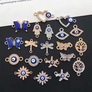 Macro shot of assorted blue Evil Eye charms in Hamsa and butterfly shapes for DIY jewelry making