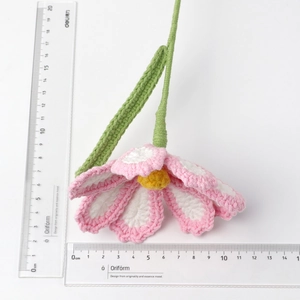 Handmade crochet pink flower with measuring rulers showing 8-9cm blossom diameter