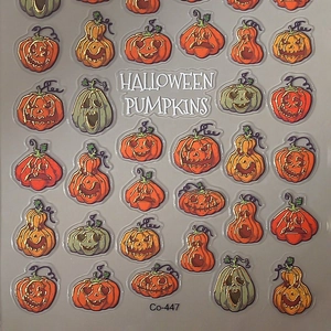 Halloween pumpkin nail art stickers set with various facial expressions and gold foil patterns