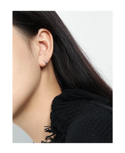Close-up of minimalist S925 sterling silver hoop earring worn on a model earlobe