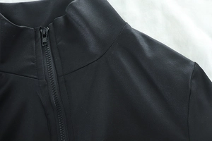 Close-up of black stand-up collar with high-quality zipper on women's athletic jacket