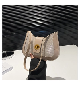 Detail of elegant crescent armpit bag showing beige PU leather and sparkling sequin texture