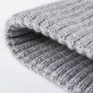 Thick grey jacquard knit beanie with ribbed texture and warm cuffed brim for winter