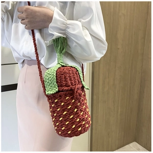 Close-up of strawberry shaped woven crossbody bag with detailed knit texture