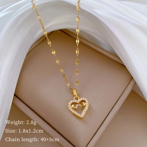 Detail of gold heart pendant with moving diamond, weight 2.8g, size 1.8x1.2cm
