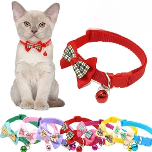 Close-up of pet collars with plaid bowknots, safety buckles, and colorful bells