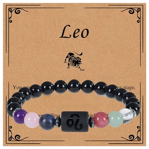 Macro shot of Leo zodiac natural stone beaded bracelet with character description card