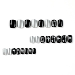 Y2K black and silver press-on nails with 24 pieces featuring metallic star patterns