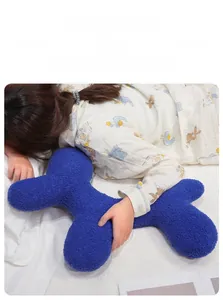 Detail of soft Klein blue bone-shaped plush pillow in a cozy home lifestyle setting