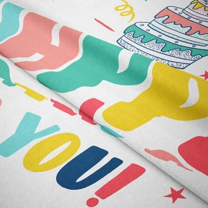 Close-up detail of soft bohemian birthday tapestry featuring a colorful cake and YOU! text