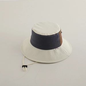 Detail view of retro color-block bucket hat with adjustable drawstring and woven label