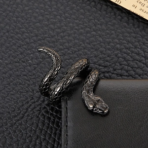 Macro shot of punk style cobra ring with realistic snake scale texture on black leather