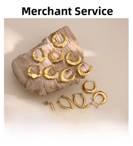Macro shot of 18K gold-plated irregular geometric earrings on natural stone