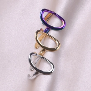 Detailed view of minimalist metallic open rings in purple, gold, and silver finishes