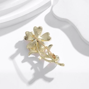 Elegant gold metal four-leaf clover brooch accessory for suits and shirts with pin closure