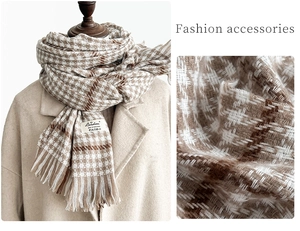 Macro shot of brown houndstooth pattern fabric texture and brand label on a warm scarf