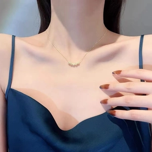 Vintage gold beaded pendant necklace shown on model for a minimalist elegant style