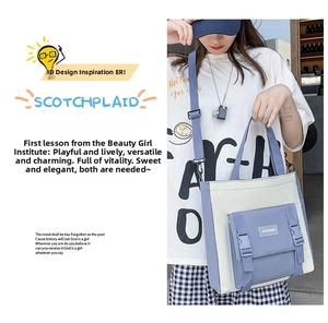 Detail of color-block canvas crossbody bag with adjustable strap and buckle pocket