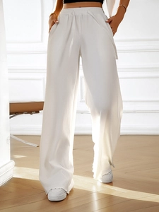 Detailed view of the textured fabric and loose fit of these white wide-leg lounge pants