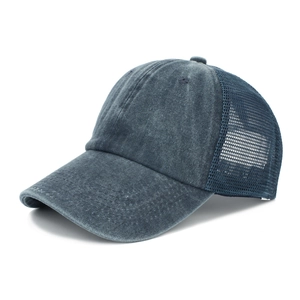 Detailed side view of washed navy blue mesh trucker hat with breathable fabric texture
