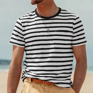Close-up of black and white striped cotton T-shirt texture on a sunny beach setting